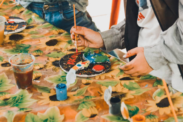 istock hand with a brush painting ceramic figure 1175322235