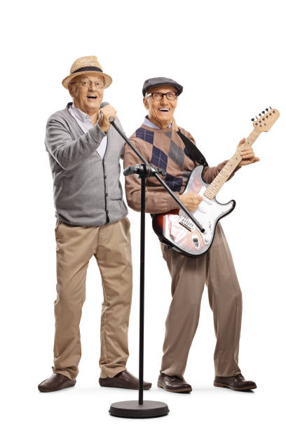 istock Senior man with a guitar and a senior man singing on a microphone 1175322895
