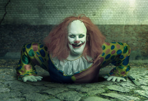 grin killer clown rising from the sewer