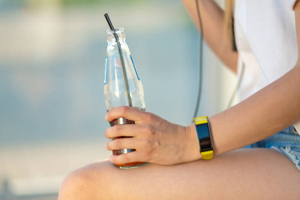 istock Close up hand hold glass bottle with soda 1175323189