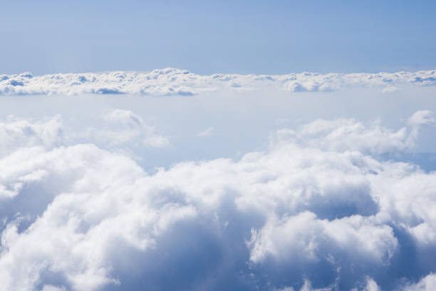 istock Fluffy clouds high view from the airplane window 1175325036