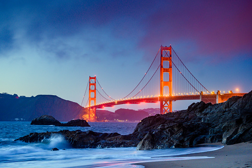 This is a photograph of the iconic Golden Gate Bridge from Baker’s Beach in San Francisco at dusk.