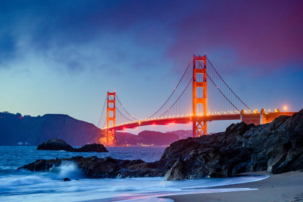 Landmark Golden Gate Bridge in San Francisco at Dusk This is a photograph of the iconic Golden Gate Bridge from Baker’s Beach in San Francisco at dusk. golden gate bridge stock pictures, royalty-free photos & images