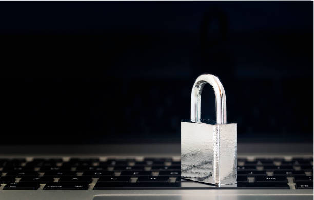 Computer Security Concept with a Closed Padlock on the Keyboard on Black Background With Reflection Screen stock photo