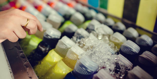 istock Selective focus to hand with fresh beverages bottles, soda, lemon, orange and water 1175340896