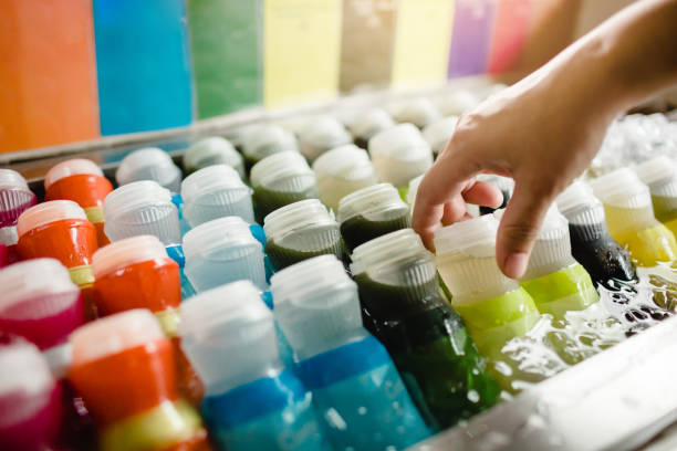 istock Selective focus to hand with fresh beverages bottles, soda, lemon, orange and water 1175340898