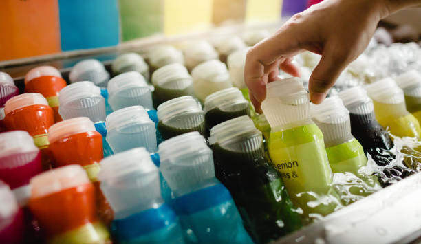istock Selective focus to hand with fresh beverages bottles, soda, lemon, orange and water 1175341406
