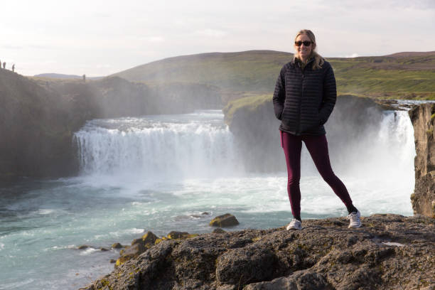 istock Young woman standing at Godafoss Waterfall in Iceland 1175344677