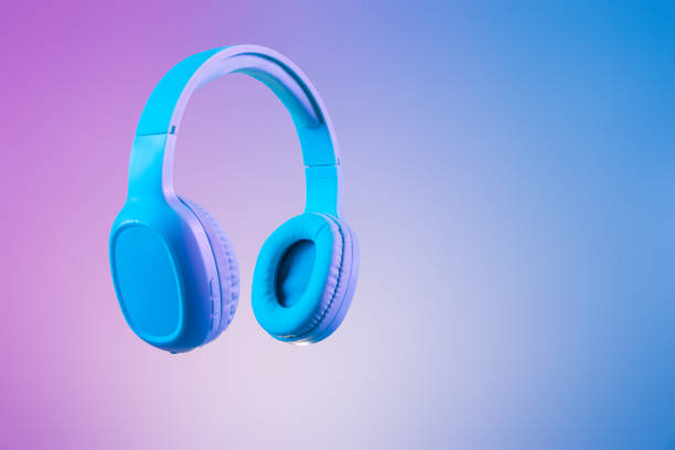 elegantes auriculares azules en iluminación de fondo multicolor / duo tono - mercancía fotos fotografías e imágenes de stock