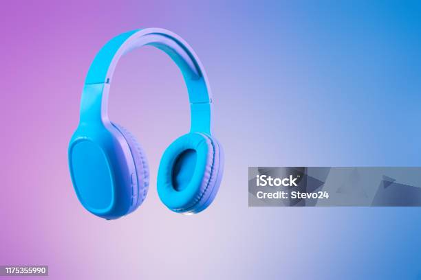 Stylish Blue Headphones On Multi Colored Duo Tone Background Lighting Stock Photo - Download Image Now