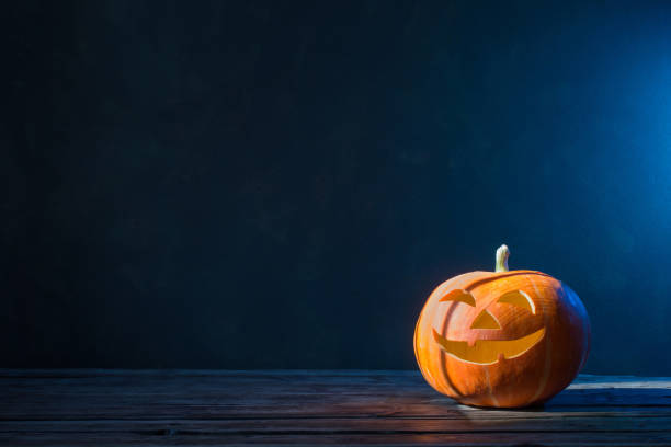 istock Halloween pumpkin on dark background 1175358087