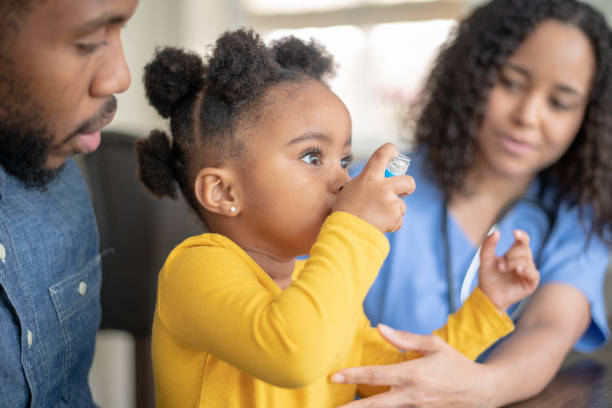 istock Girl at doctor's appointment using an asthma inhaler 1175358202