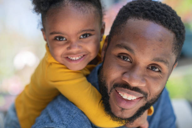 istock Dad giving daughter a piggy back ride 1175358242