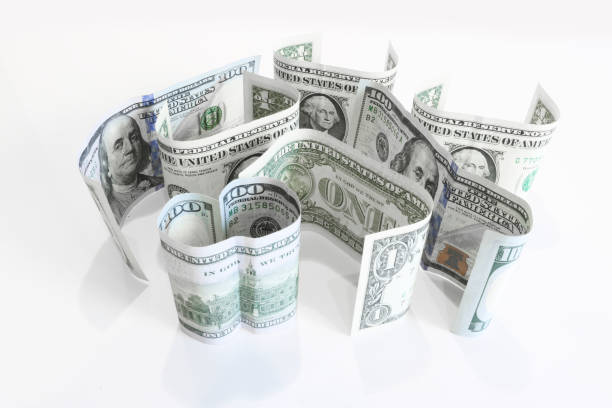 istock American currency - one-dollar and hundred-dollar bills stand on a surface. 1175358253