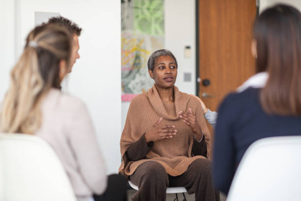 istock Female phycologist leads group therapy session 1175358258