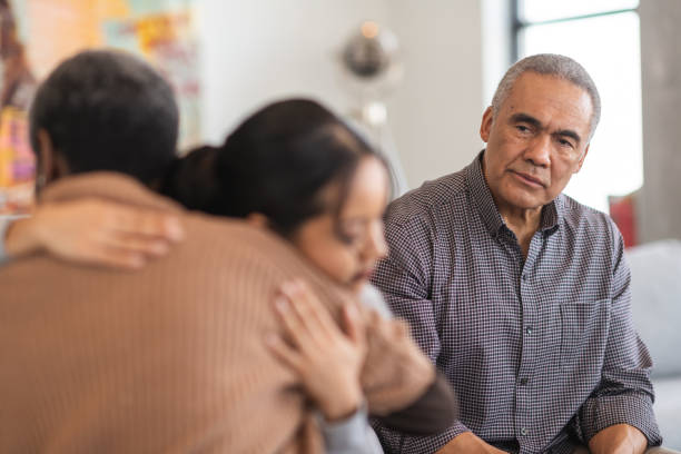 istock Thoughtful psychologist watches group therapy attendees hug 1175358265