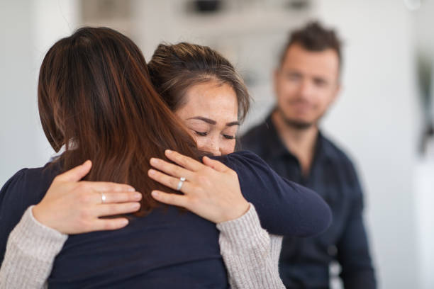 istock Friends share a tearful hug in therapy session 1175358266