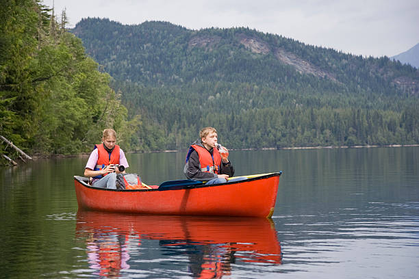 istock Girl and boy canoeing 117536279