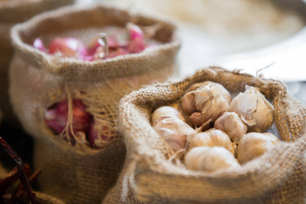 Close up of Garlic in cloth sacks on blurred background