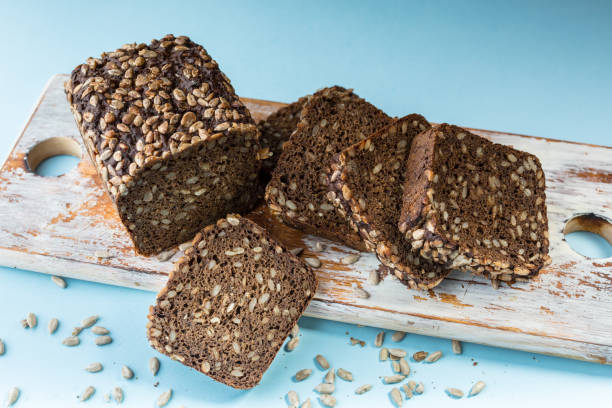 istock Rye yeast-free bread with sunflower seeds on a blue background. 1175374409