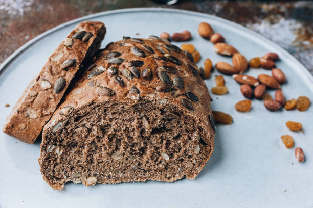 istock Rye bread with pumpkin seeds and nuts on a large light plate. 1175374442