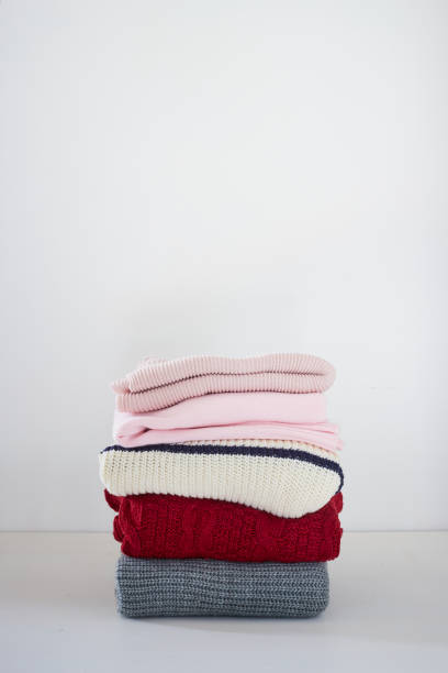 istock knitted sweater on a wooden white table, space for text 1175375316