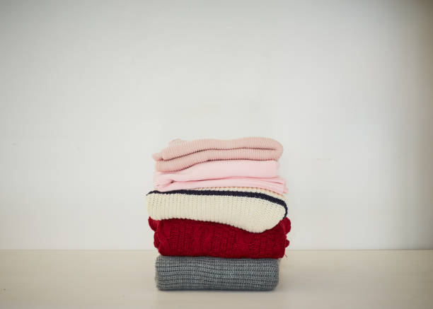 istock knitted sweater on a wooden white table, space for text 1175375317
