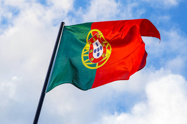 istock Portuguese flag waving in front of a blue sky. 1175376193