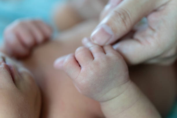istock Newborn baby holding hand mother 1175378383