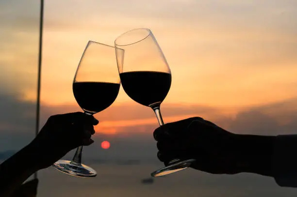 Photo of Couple with glasses of red wine in luxury restaurant.