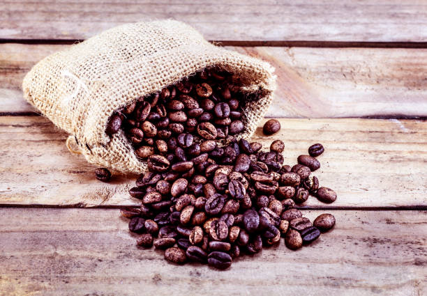 istock Roasted coffee beans in a sack on a wood 1175379280