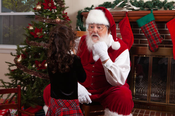 istock Santa chatting with a little girl 1175383680
