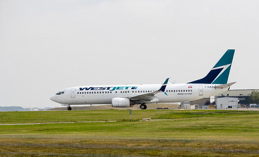 A WestJet Airlines Boeing 737, with identification C-GJLZ, preparing for take off from Calgary International Airport on September 16, 2019