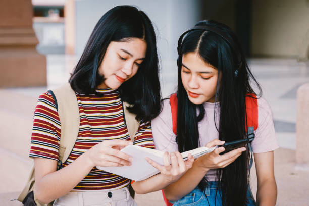 istock Asian university students chating, talking in university campus. 1175392628