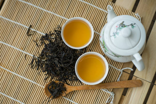 Cup with green tea on the table. Cup with green tea on the table. oolong tea stock pictures, royalty-free photos & images
