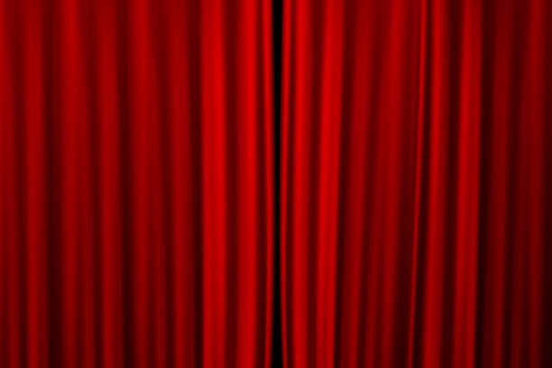 istock Red curtain on theater or cinema stage slightly open 1175396147