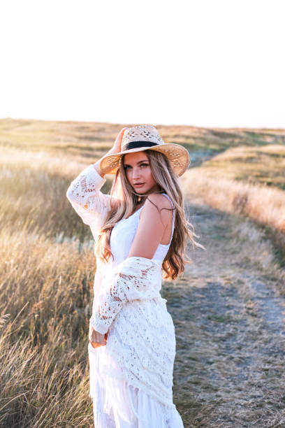 istock Beautiful woman enjoying nature outdoors at sunset. 1175396434