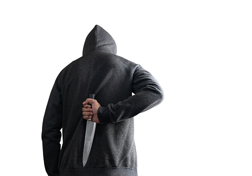 The bandits in the black hold a knife hidden behind on white background. with clipping path.
