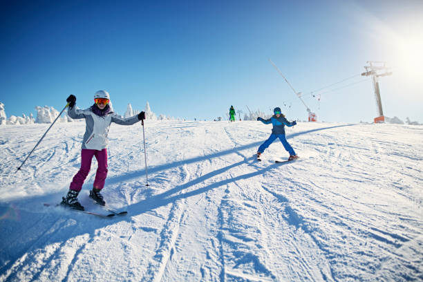 istock Family having fun skiing together on winter day 1175399857