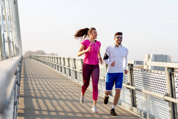 istock Couple jogging at the bridge 1175400482