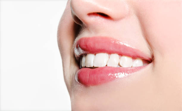 istock Smiling woman mouth with great white teeth on a white background 1175403500