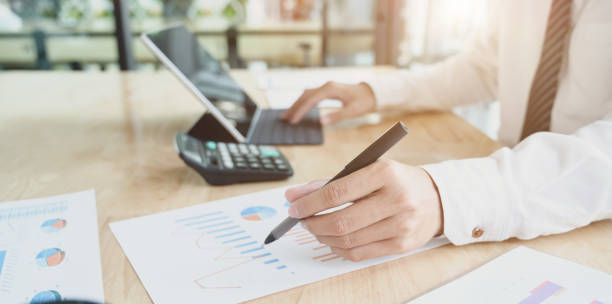 istock Male accountant compiling and analysing financial information to his client 1175404650