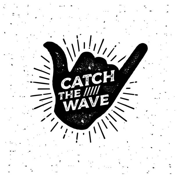 Catch the wave Black Shaka Vector illustration Catch the wave. Surfing lettering shaka print vector for flyer, poster,  or t-shirt print. breaking wave stock illustrations