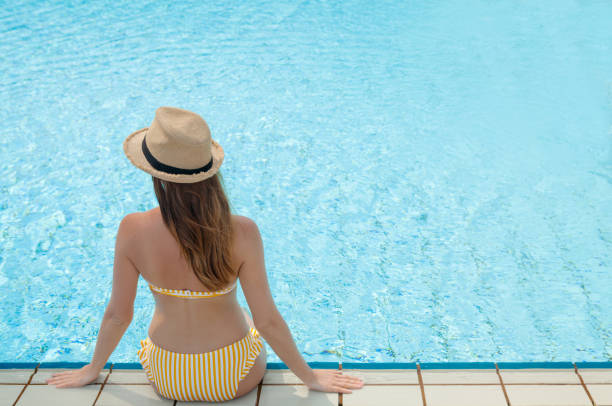 istock Young woman relaxing in swimming pool 1175406629