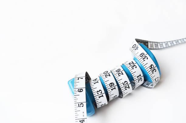 istock Fitness concept dumbbell and measuring tape 1175407237