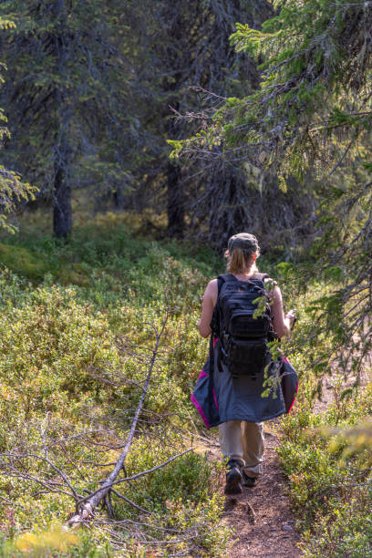 istock Woman hiking in forest path 1175409005
