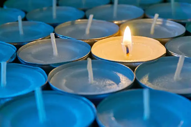 Photo of Tea lights with one being lit