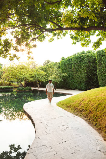 istock stylish man walking in a garden 1175412832