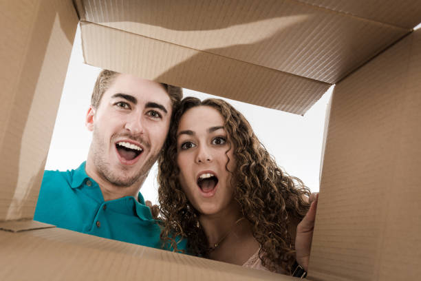 istock Couple opening cardboard box very happy 1175412883