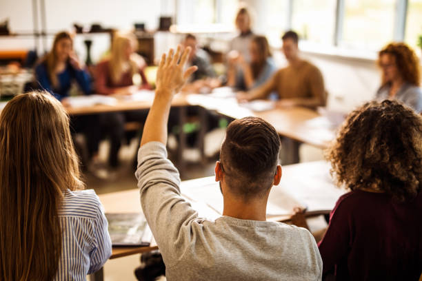 istock Back view of college student wants to ask something on a class. 1175412887